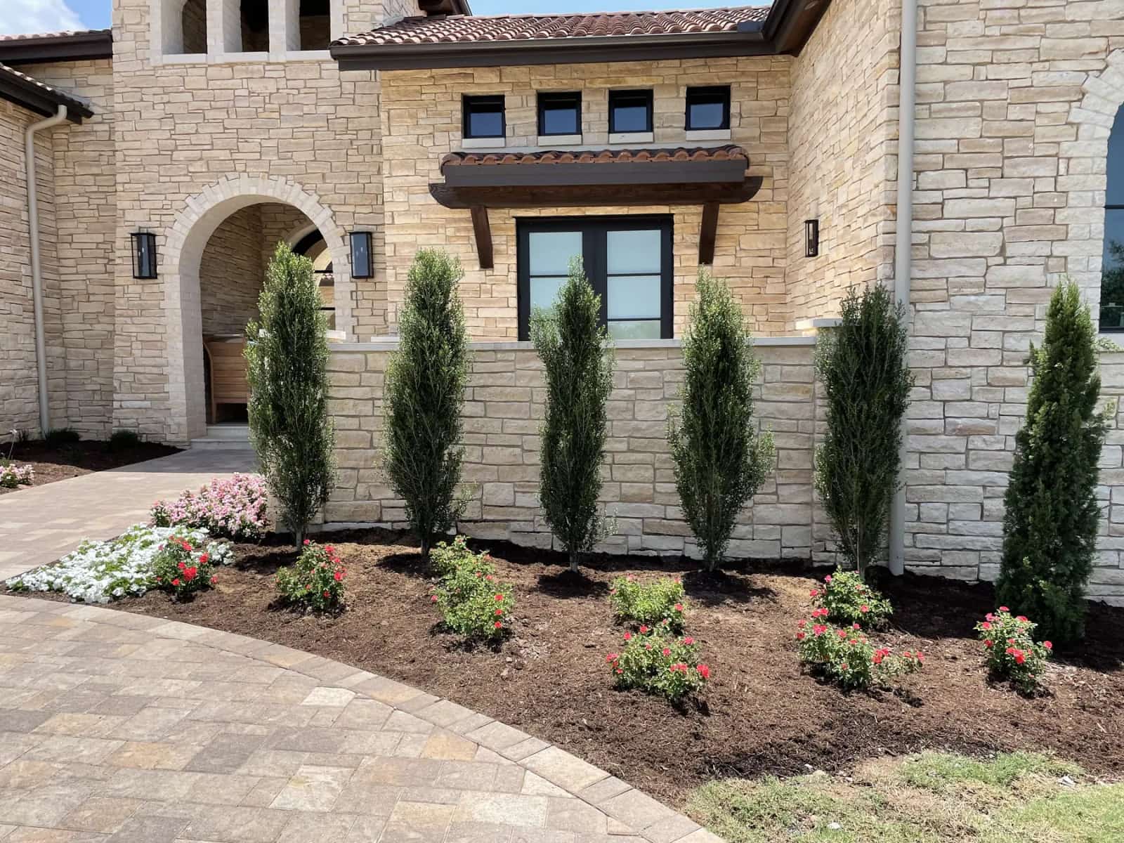 Austin limestone home with structured climate-adapted foundation planting